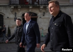 Britain’s Foreign Secretary David Cameron walks in the city center with Lviv Mayor Andriy Sadovyi as he visits Ukraine on May 3, 2024.