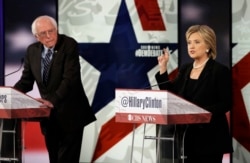 FILE - Hillary Rodham Clinton, right, makes a point as Bernie Sanders listens during a Democratic presidential primary debate in Des Moines, Iowa, Nov. 15, 2015.