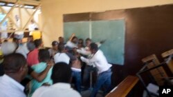 A fight breaks out inside a voting center during parliamentary elections in Port-au-Prince, Haiti, Sunday, Aug. 9, 2015. 