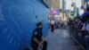 A New York City police officer takes a knee during a demonstration by protesters in Times Square, May 31, 2020, over the death of George Floyd in police custody.