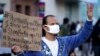 FILE - In this March 13, 2021, file photo, a man participates in the rally "Love Our Communities: Build Collective Power" to raise awareness of anti-Asian violence outside the Japanese American National Museum in Little Tokyo in Los Angeles. Asian…