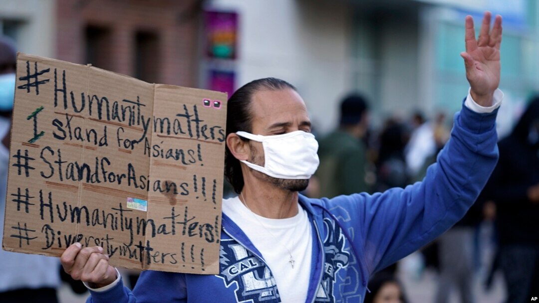 FILE - In this March 13, 2021, file photo, a man participates in the rally ‘Love Our Communities: Build Collective Power’ to raise awareness of anti-Asian violence outside the Japanese American National Museum in Little Tokyo in Los Angeles.