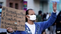 FILE - In this March 13, 2021, file photo, a man participates in the rally ‘Love Our Communities: Build Collective Power’ to raise awareness of anti-Asian violence outside the Japanese American National Museum in Little Tokyo in Los Angeles.
