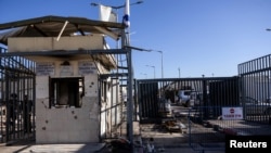 FILE - View of a damaged entrance to the Israeli military headquarters of the Coordination and Liaison Administration to Gaza, that was attacked on October 7 by gunmen from Palestinian Islamist group Hamas, near Erez crossing in southern Israel, December 15, 2023.