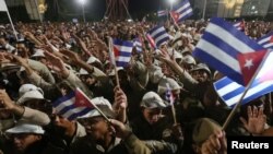 People wave Cuban flags as they attend a massive tribute to Cuba's late former president, Fidel Castro, in Revolution Square in Havana, Cuba, Nov. 29, 2016. 