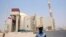 File - A security official stands in front of the Bushehr nuclear reactor, 1,200 km (746 miles) south of Tehran, August 21, 2010. 