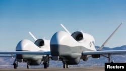 FILE - Two Northrop Grumman MQ-4C Triton unmanned aerial vehicles are seen on the tarmac at a Northrop Grumman test facility in Palmdale, Calif., May 22, 2013, in this handout photo provided by the U.S. Navy May 22, 2013.