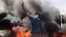 A man flashes the victory sign during a protest to denounce the October military coup, in Khartoum, Sudan, Dec. 25, 2021.