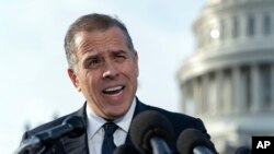FILE - Hunter Biden, son of President Joe Biden, talks to reporters at the U.S. Capitol, in Washington, Dec. 13, 2023. An FBI informant has been charged with lying to his handler about ties between Joe Biden and son Hunter and a Ukrainian energy company. 