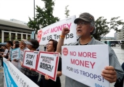 FILE - South Korean protesters shout slogans during a rally demanding withdrawal of the U.S. troops from Korea Peninsula near the U.S. embassy in Seoul, South Korea, July 31, 2019.