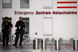 FILE - Police officers stand outside the Charite Mitte Hospital Complex, where Russian opposition leader Alexei Navalny is receiving medical treatment, in Berlin, Germany, Aug. 24, 2020.