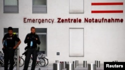 FILE - Police officers stand outside the Charite Mitte Hospital Complex, where Russian opposition leader Alexei Navalny is receiving medical treatment, in Berlin, Germany, Aug. 24, 2020.