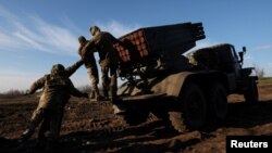 Service members with the Ukrainian Army's 10th Mountain Assault Brigade unit prepare a BM-21 Grad self- propelled multiple rocket launcher, as Russia's attack on Ukraine continues, for launching near the frontlines in the Bakhmut region of Ukraine, Dec. 7, 2022. 