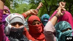 FILE - Villagers shout slogans during a protest in New Delhi, India, April 22, 2014, against the rape of a lower caste Dalit in Haryana state.
