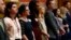 Legislative aides stand in unison during the reading of a Democratic resolution calling for the expulsion of Colorado state Sen. Randy Baumgardner, R-Hot Sulphur Springs, during a debate on the chamber's floor April 2, 2018.