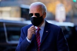 FILE - President-elect Joe Biden walks from his motorcade to speak to reporters in Wilmington, Del., Nov. 23, 2020.