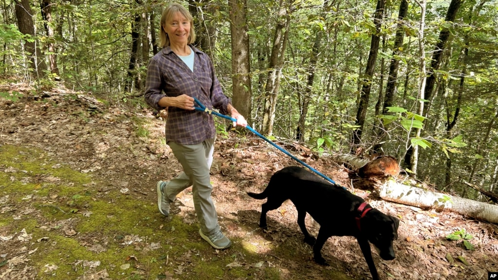 FILE - Susannah Johnston, of Croton-on-Hudson, N.Y., walks her dog Ellie on Sept. 8, 2024 in Norfolk, Conn. Johnston, a fit yoga instructor and strength trainer, has been injured three times in incidents involving walking her dog. (Vincent Cohan via AP)