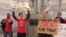 Whitney Walker, second left, and Tracy Kurzendoerfer protest outside of Kentucky Gov. Matt Bevin's office, March 30, 2018, in Frankfort, Ky. Walker and Kurzendoerfer are teachers in Fayette County. Both called in sick Friday to protest a bill lawmakers passed late Thursday that makes changes to the state's pension system.