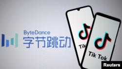FILE - Tik Tok logos are seen on smartphones in front of a displayed ByteDance logo, Nov. 27, 2019. 