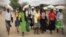 FILE: People take advantage of a maize distribution program in Zimbabwe. (Credit: World Food Program)