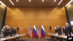 US Deputy Secretary of State Wendy Sherman, left, and Russian deputy Foreign Minister Sergei Ryabkov, right, attend security talks at the United States Mission at the United States Mission in Geneva, Switzerland, Jan. 10, 2022.