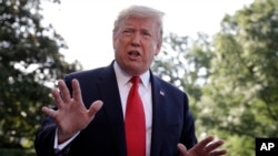 President Donald Trump talks with reporters before departing on Marine One, May 30, 2019, in Washington.