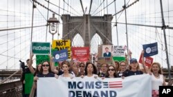 FILE - Hundreds of demonstrators march across the Brooklyn Bridge to call for tougher gun control laws, June 14, 2014, in New York. 