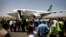 FILE - Yemeni airport security and transportation officials greet a plane from the Iranian private airline, Mahan Air after it lands at the international airport in Sana'a, Yemen.