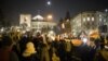 FILE - Demonstrators wave Polish and European Union flags during a protest outside the Parliament building in Warsaw, Jan. 11, 2017.