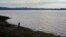 FILE - A fisherman walks on the shore of the fishing village Quetalmahue in Chile's Chiloe island, May 10, 2016. Scrub typhus has been confirmed in a cluster of cases on the island, far from places it usually strikes.