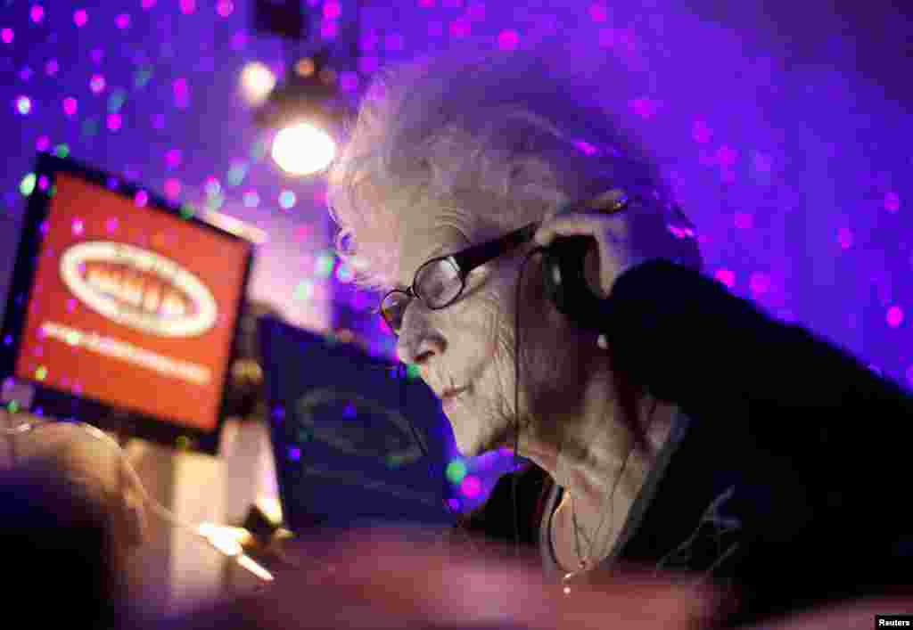 DJ Wika Szmyt, 73, plays music at a club in Warsaw January 4, 2012. (Reuters)