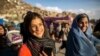 Young Afghan women are seen smiling in Kabul March 26, 2014.