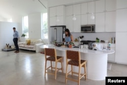 Lawrence Nourzad and Angela Hontas spend time in their newly purchased 3D-printed home in Georgetown, Texas, June 26, 2024. (REUTERS/Evan Garcia)