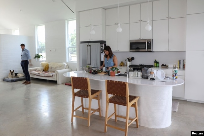 Lawrence Nourzad and Angela Hontas spend time in their newly purchased 3D-printed home in Georgetown, Texas, June 26, 2024. (REUTERS/Evan Garcia)