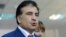 Georgia's President Mikheil Saakashvili speaks to journalists at a polling station in Tbilisi, on October 1, 2012.