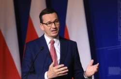 FILE - Poland's Prime Minister Mateusz Morawiecki speaks during a press conference in Vilnius, Lithuania, Sept. 17, 2020.