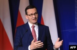 FILE - Poland's Prime Minister Mateusz Morawiecki speaks during a press conference in Vilnius, Lithuania, Sept. 17, 2020.