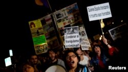 People attend a protest calling the government to ban the burial of Spanish dictator Francisco Franco in Madrid's Almudena Cathedral, after he is exhumed from the Valley of the Fallen, in Madrid, Oct. 25, 2018.