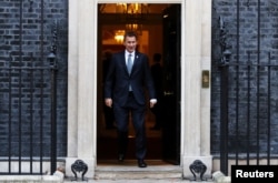 FILE - Britain's Foreign Secretary Jeremy Hunt leaves 10 Downing Street, London, Britain, Nov. 13, 2018.