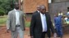 Elton Mangoma, centre, Zimbabwe's Minster of Energy and Power Development outside the magistrates courts. (AP Photo/Tsvangirayi Mukwazhi)