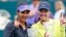 Sania Mirza (kiri) dan pasangan gandanya, Martina Hingis, dari Swiss dengan trofi mereka dari turnamen Family Circle Cup (12/4) di Charleston, South Carolina. (AP/Mic Smith)