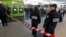 Police officers stand near the cordoned off spot where a French soldier was stabbed in the throat in the busy commercial district of La Defense, outside Paris, May 25, 2013.