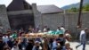 People carry the body of the victim who has been identified as Zelimkhan Khangoshvili, a Georgian Muslim who fought against Russia in the Second Chechen War during the funeral in Duisi village, the Pankisi Gorge valley, in Georgia, Aug. 29, 2019.