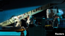 FILE - Airmen load pallets of cargo into a C-130J Super Hercules in support of a U.S. Africa Command task force, at Spangdahlem Air Base, Germany, March 20, 2011. U.S. Africa Command confirmed Friday it is moving its headquarters out of Germany.