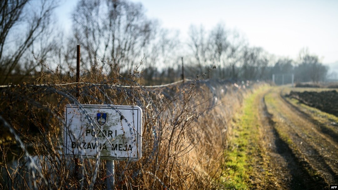 A placard saying "Attention! State border" is displayed on a barbed wire fence at the Slovenian-Croatian border close to the village of Rigonce, in Slovenia on Feb. 16, 2017.