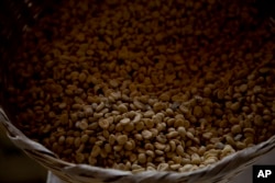 FILE - Arabica coffee beans harvested the previous year are stored at a coffee plantation in Ciudad Vieja, Guatemala, on May 22, 2014. (AP Photo/Moises Castillo, File)
