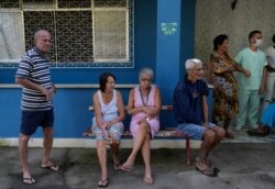 Elderly residents wait for a dose of the Pfizer COVID-19 vaccine, during a booster shot campaign for the elderly in long-term care institutions, at Casa de Repouso Laco de Ouro nursing home, in Rio de Janeiro, Brazil, Sept. 2, 2021.