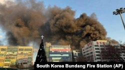 Smoke rises at the scene of a fire at a commercial building in Seongnam, South Korea, Jan. 3, 2025.