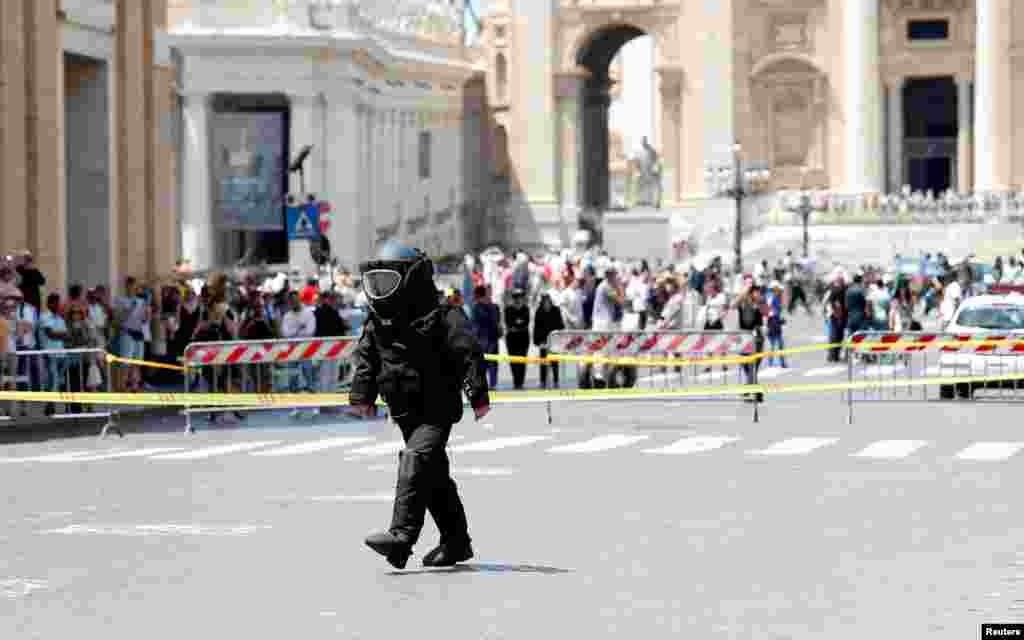 A police officer from the bomb disposal unit checks the area after an alarm near the Vatican, in Rome, Italy.