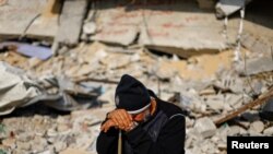 FILE - Ziad Mansour, a neighbor of the Abu Aweidah family, amid the rubble of the family's house, which was destroyed in a deadly Israeli strike in Rafah, Gaza Strip, January 9, 2024.